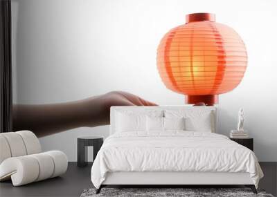 Close up photograph of a human hand holding a traditional Chinese lantern a symbol of the Mid Autumn Festival against a plain white background with ample negative space Wall mural