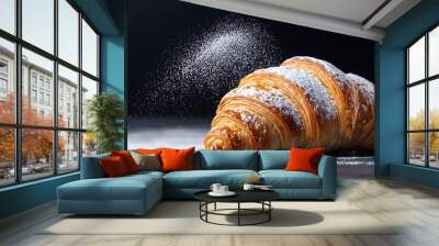 Closeup of a freshly baked and golden brown croissant pastry dusted with a light coating of powdered sugar arranged on a plain table surface with copy space Wall mural