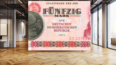 2 mark coin against historic 50 east german mark bank note Wall mural