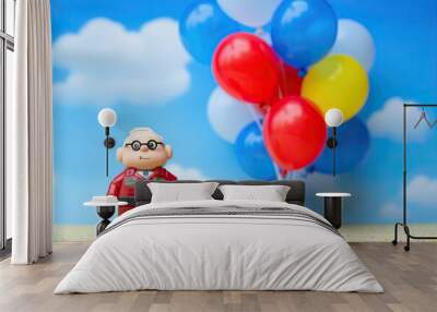 Happy Senior with Colorful Balloons Against Blue Sky - Toy Figure. Generative AI. Wall mural