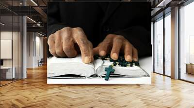 black man praying to god with crucifix and hands together Caribbean man praying on black background with people stock photos stock image	 Wall mural