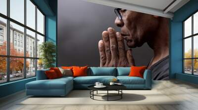 black man praying to god with hands together Caribbean man praying stock photo	 Wall mural