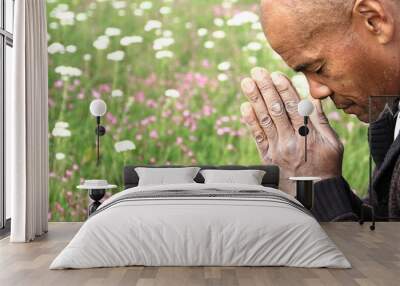 black man praying to god with hands together stock photo Wall mural