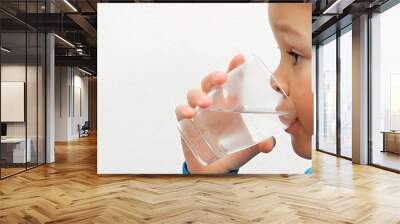 boy drinking water from a glass with white background stock photo Wall mural