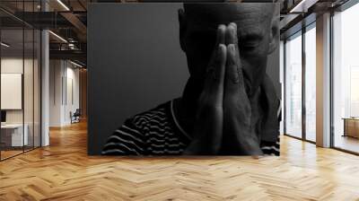 man praying to god with hands together Caribbean man praying on black background with people stock photos stock photo	 Wall mural