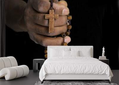 man praying to god with hands together Caribbean man praying on white background with people stock photo Wall mural