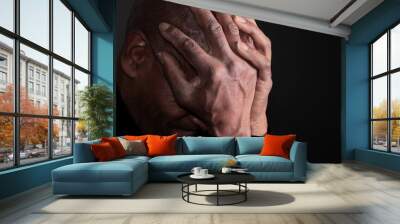 man praying to god with hands together on black background stock photo Wall mural