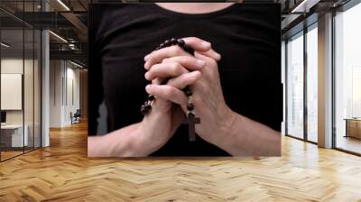 praying to God with hands together on grey black background with people stock image stock photo Wall mural