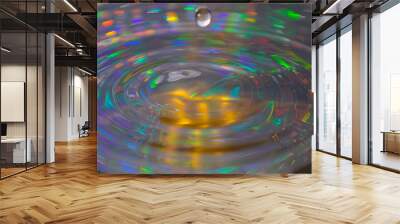 A stunning indoor shot captures a water droplet, its surface reflecting intricate patterns and light. The interplay of color and detail transforms simplicity into art. Wall mural