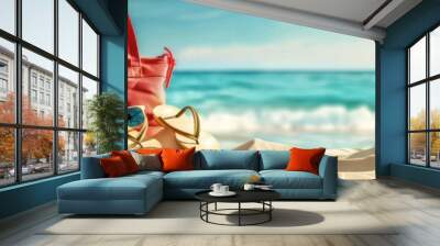 Sunny summer background with beach bag, sunglasses and flip-flops on the sand Wall mural