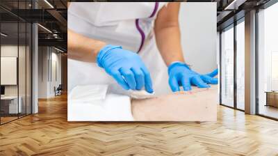 hand of Doctor is using clean cotton dressing infection wound at a man abdomen. Bandage for wound dressing at a clinic. medical care healthcare insurance concept. High quality photo Wall mural