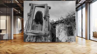 Horror Scene of a scary girl over a spooky  house background Wall mural