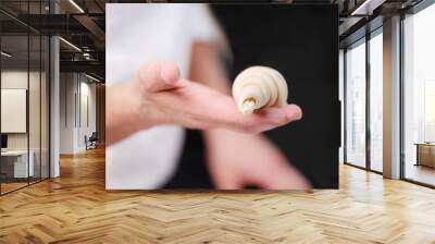 pastry chef hand showing a fresh uncooked croissant . Wall mural