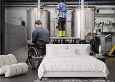 Person with disability who uses a wheelchair working at craft beer factory. High quality photography. Wall mural