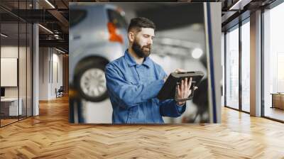  ar mechanic with a tablet near car in work clothes Wall mural