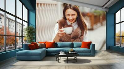 The girl on the street. Woman and coffee. Beautiful girl resting Wall mural