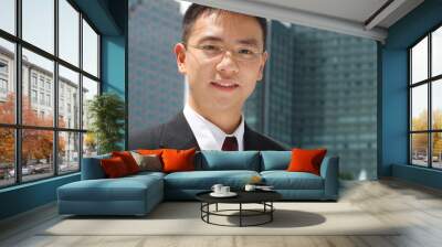 young asian executive in front of office buildings Wall mural