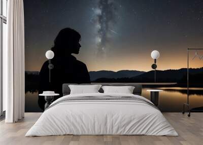 A starry night sky with a silhouette of a person gazin Wall mural