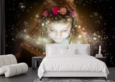 Beautiful little girl reading magic book Wall mural