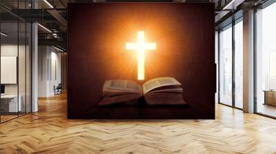 Open book with glowing cross above it; religion concept Wall mural