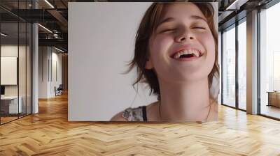 Young brunette woman over isolated white background laughing
 Wall mural