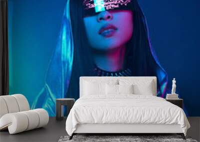 Neon portrait of a girl of Asian appearance, dressed in futuristic clothes and glasses. Neon blue and pink light. Virtual reality glasses and binary code in them. Wall mural