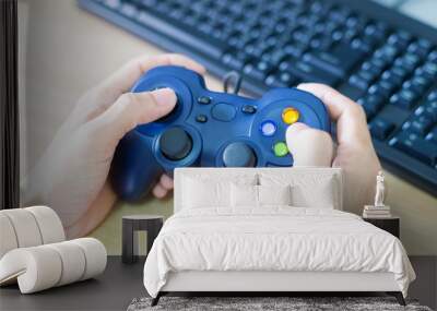 Hands man hold a joystick to play video game blurred background Wall mural