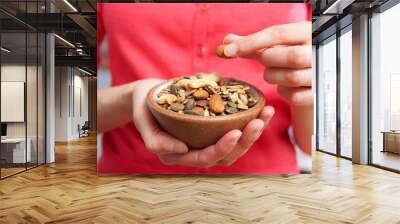 Close Up Of Woman Eating Bowl Of Healthy Nuts And Seeds Wall mural