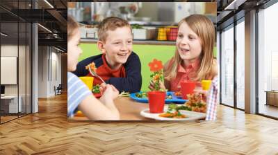 Group Of Pupils Sitting At Table In School Cafeteria Eating Lunc Wall mural