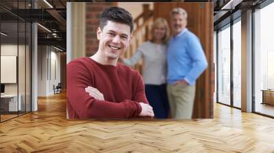 Portrait Of Young Man With Parents At Home Wall mural