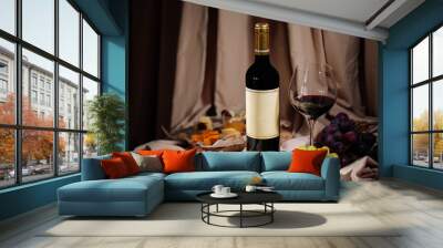 Bottle and glass of red wine with appetizers on cloth background Wall mural