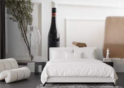 Bottle of wine and vase on white coffee table Wall mural