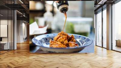 Cooking karaage chicken, japanese fried chicken with sauce in a traditional blue bowl, upright Wall mural