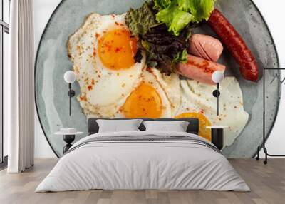 Portion of fried eggs with sausages breakfast Wall mural