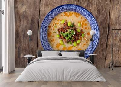 Top view on appetizing asian japanese ramen noodle soup tantanmen in a traditional blue bowl on the dark wooden table, horizontal Wall mural