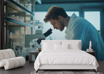 scientist in a lab coat analyzing samples under a microscope in a modern laboratory, copy space Wall mural