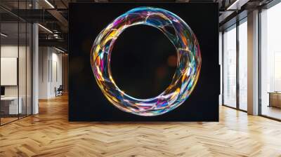 A shimmering, 3D circle of liquid glass floats against a black background. It has a holographic effect and looks like a soap bubble, reflecting light. Wall mural