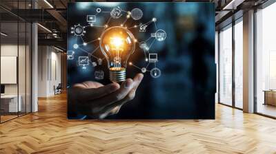 Businessman’s hand holding a creative light bulb with industry network, analysis solutions, development marketing network icons, and strategic planning. Modern business and innovation of new ideas. Wall mural