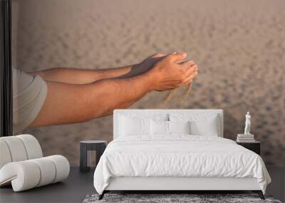 Sand flowing through man's hands in the sunset sunlight, white sand, holiday idea Wall mural