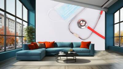 Stethoscope with protective mask on white background. Novel coronavirus 2019-nCoV, MERS-CoV middle East respiratory syndrome coronavirus. Wall mural