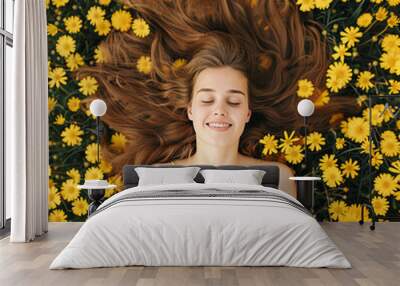 Girl in a yellow dress laying in a field of flowers Wall mural