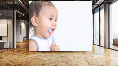 Asian baby girl brushing her teeth Wall mural