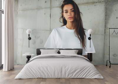 A beautiful mockup of an oversized white blank t-shirt, worn by a woman with tattoos and long hair in the street Wall mural