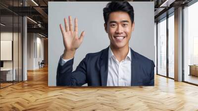 A young, attractive businessman displaying his five fingers to the camera. Wall mural