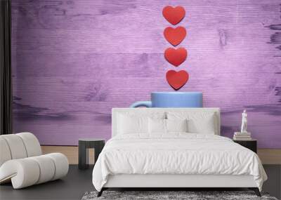 Cup of coffee with hearts on a wooden background Wall mural