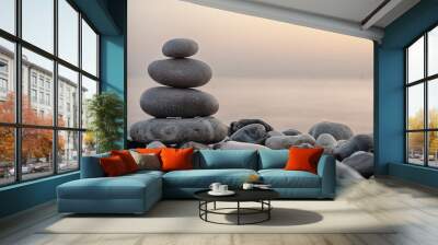 Stack of round smooth stones on a seashore Wall mural