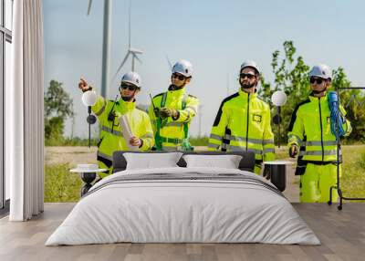 Four young male wind farm engineers work inspecting field systems.Wind turbine engineer inspection and wind turbine inspection progress at construction site. Wall mural