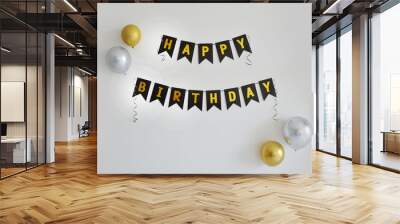 Golden and black Happy Birthday banner on white wall with silver and gold balloons Wall mural