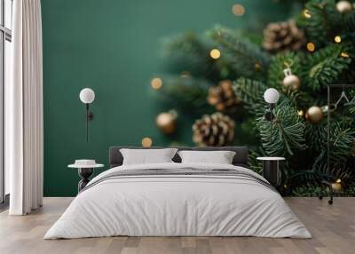 Festive Christmas Tree Branch with Garland on Green Background Wall mural