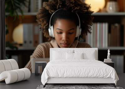 Professional multitasking: Young businesswoman using headset while working on laptop in a modern office Wall mural